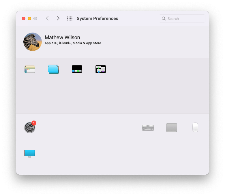 An edited screenshot of the macOS 12 Monterey System Preference pane showing just 9 of the 34 icons: An @ sign, a three person icon, a two4 icons depicting the Mac UI, 1 icon of a monitor, 1 icon of a keyboard, 1 icon of a track pad, 1 icon of a mouse, and a cog icon with a single notification.