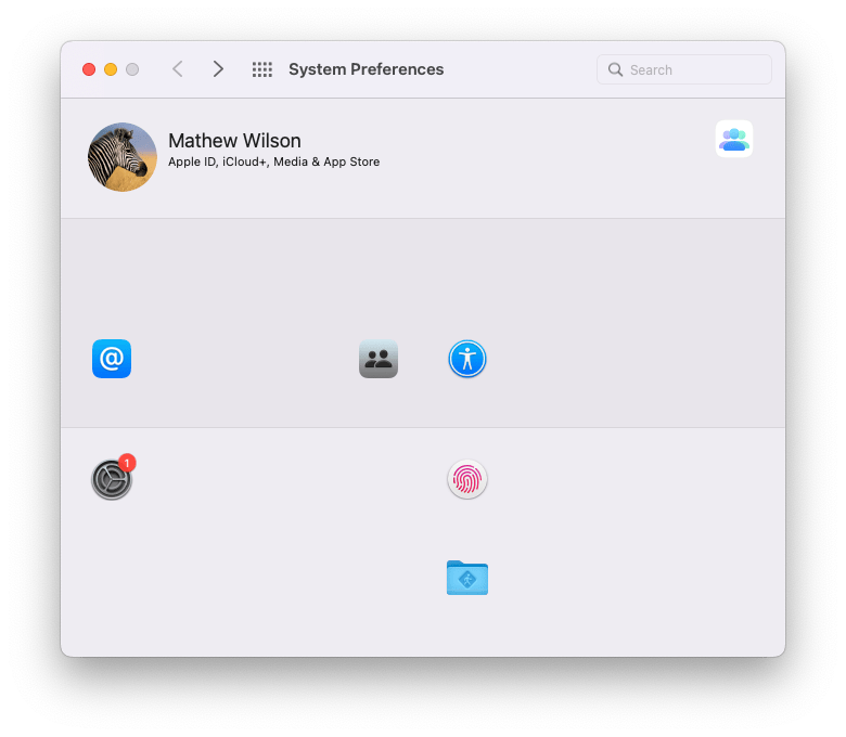 An edited screenshot of the macOS 12 Monterey System Preference pane showing just 7 of the 34 icons: An @ sign, a three person icon, a two person icon, a one person icon, a blue folder with a person icon, a fingerprint icon and a cog icon with a single notification.